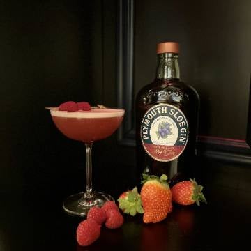 Love club cocktail med en flaske Plymouth Gin, jordbær og hindbær.