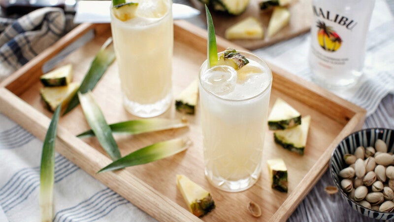 Pina colada cocktails på en bakke med ananas.